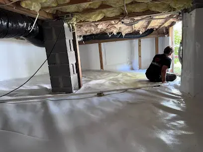 Crawl space with new vapor barrier after water damage drying